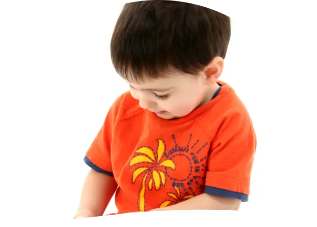 A young boy in an orange t-shirt with a palm tree graphic looks downward against a white background.